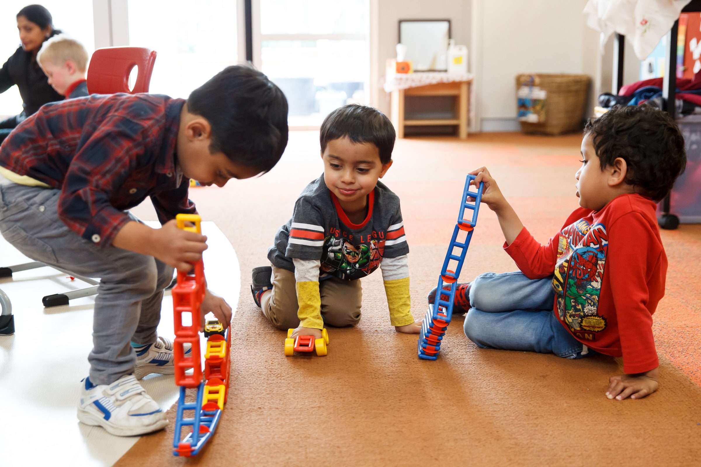 3 young boys playing with connector blocks