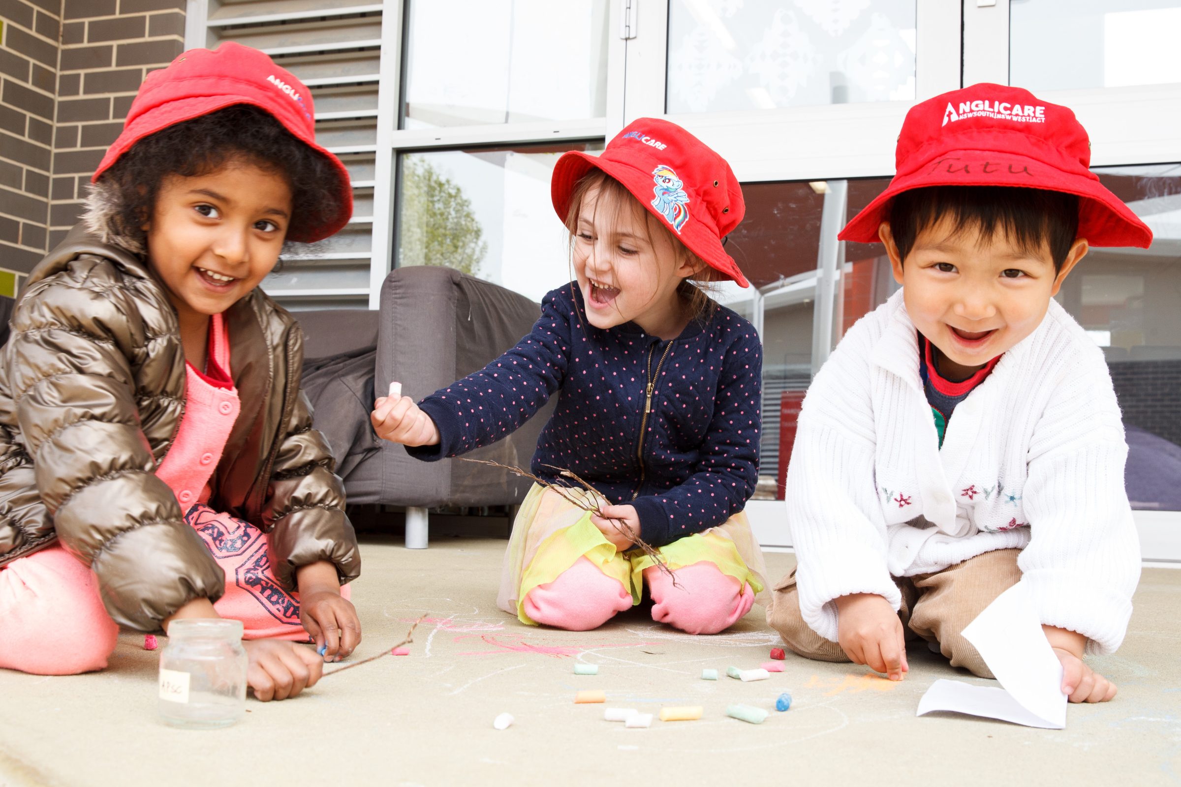 3 preschoolers playing with craft