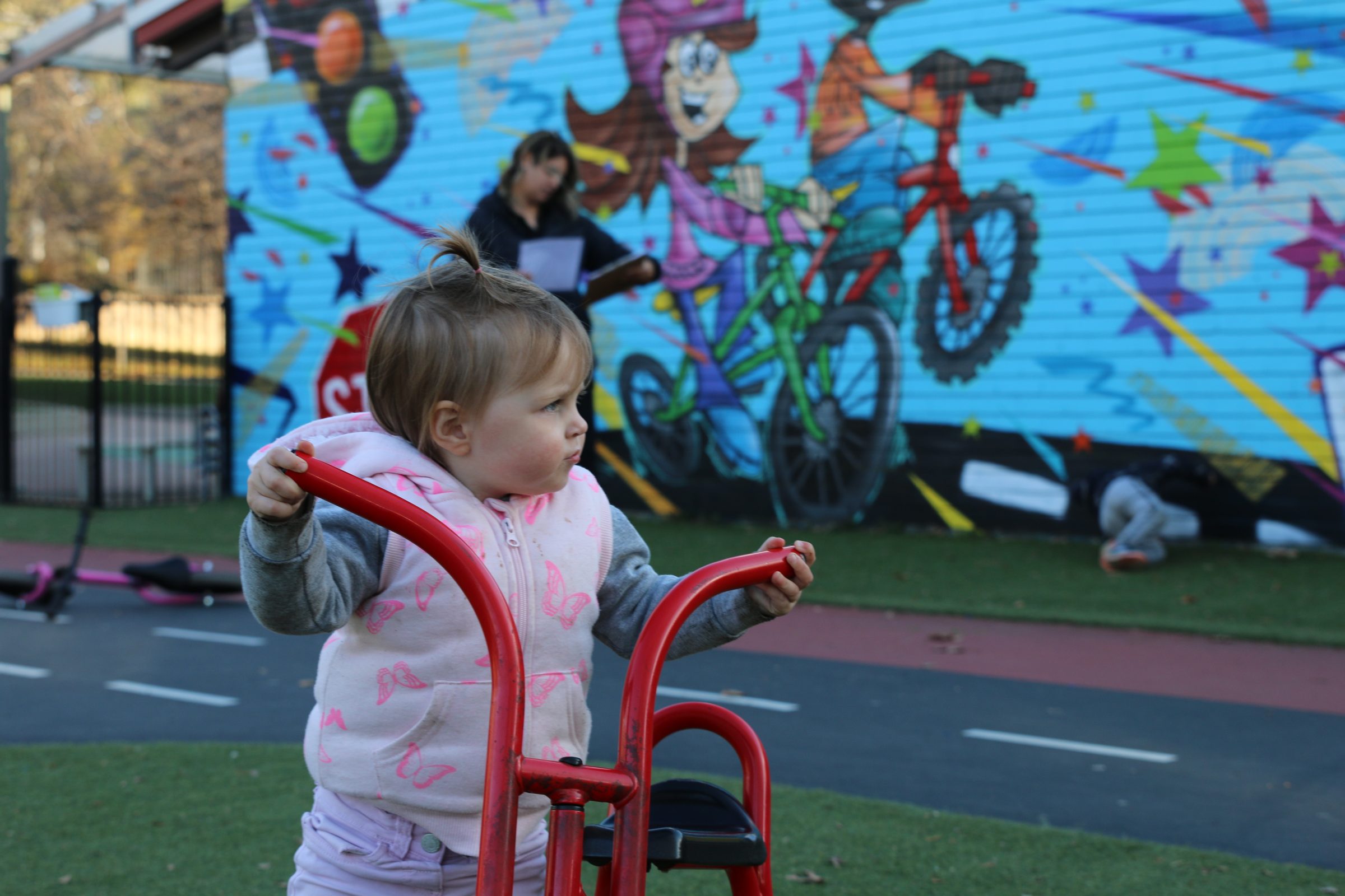 toddler beside tricycle